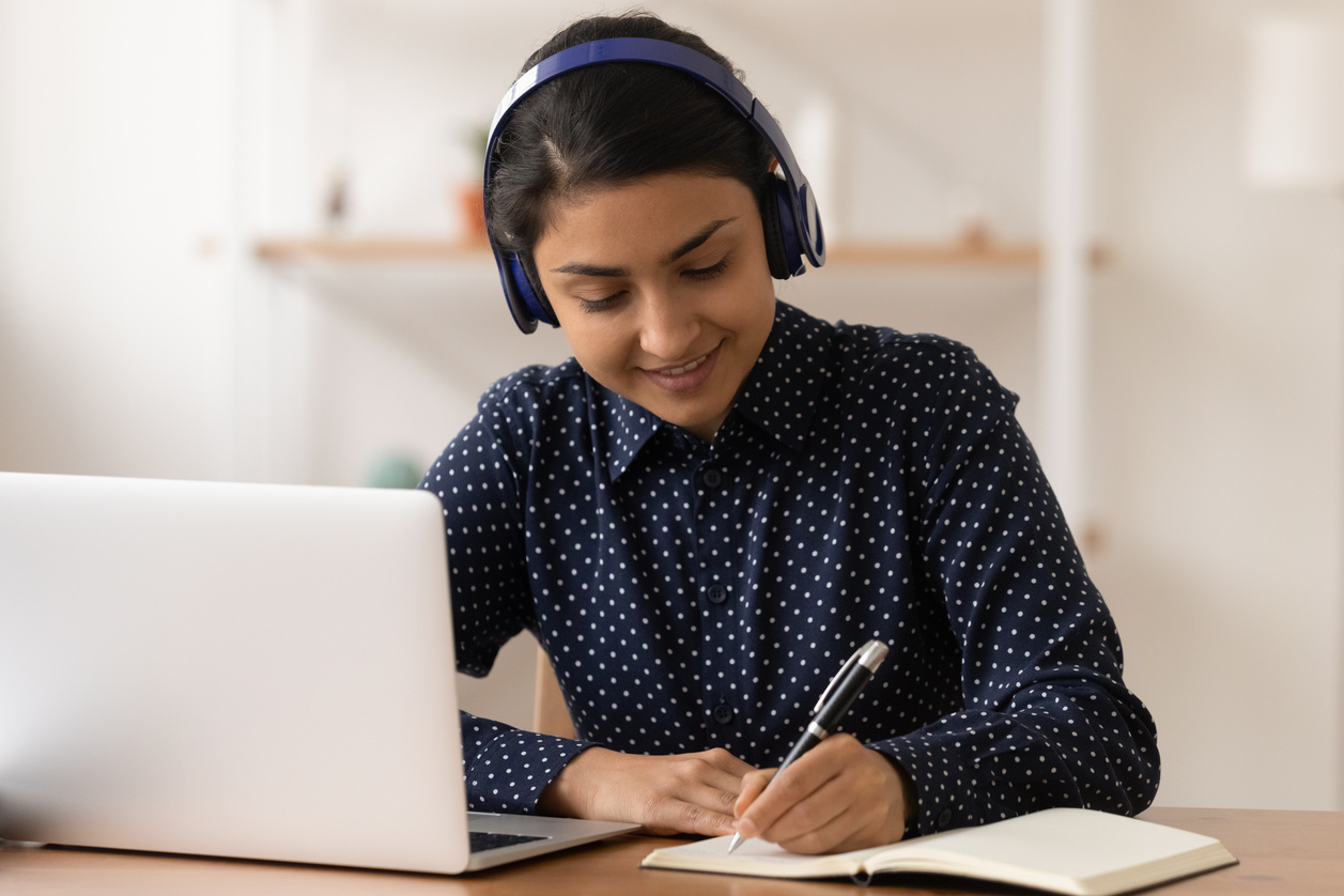 Young Woman Wearing Headphones During an Online Class